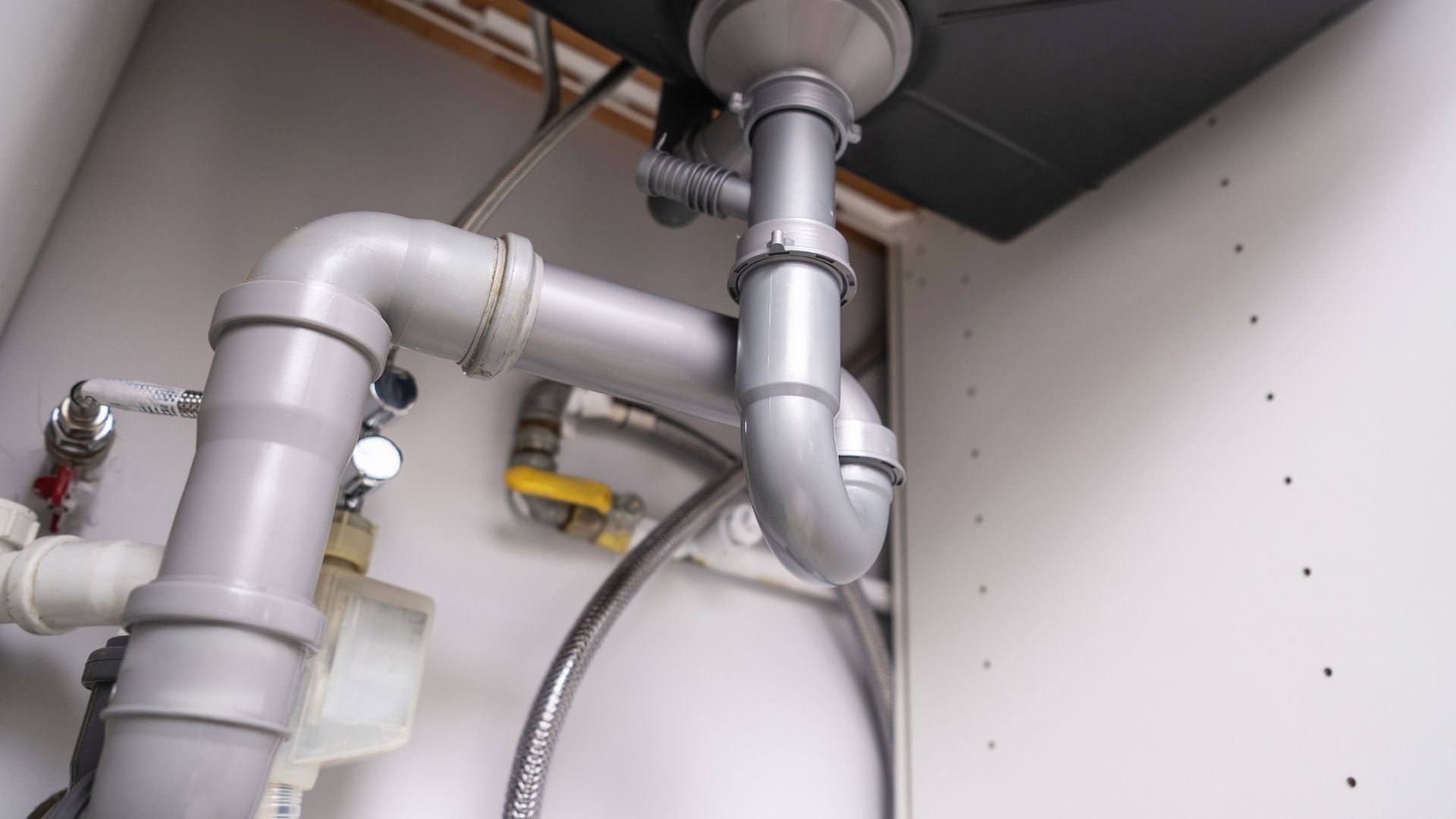 Chrome under-sink P-trap and plumbing pipes with shut-off valve and flexible hose